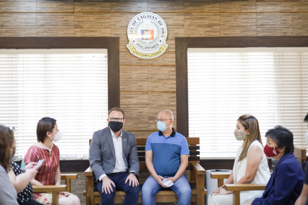 The maple has landed: Canadian Embassy Second Secretary for Domestic Affairs Peter Wright (seated in center, wearing black face mask) and Program Assistant Tiffany Urrutja (partially hidden, second from left), pay a courtesy call to Cagayan de Oro City Mayor Roland “Klarex” A. Uy, with (from left) City Councilors  Joyleen Mercedes “Girlie” Balaba and Imee Rose Moreno, and Local Economic and Investment Promotions Officer (LEIPO) Eileen E. San Juan.